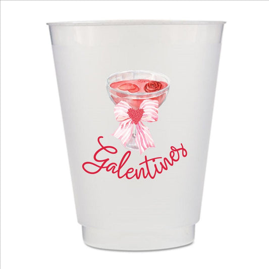 A white plastic cup with a printed design featuring a glass of red wine with a bow and the word "Galentines" written below it.